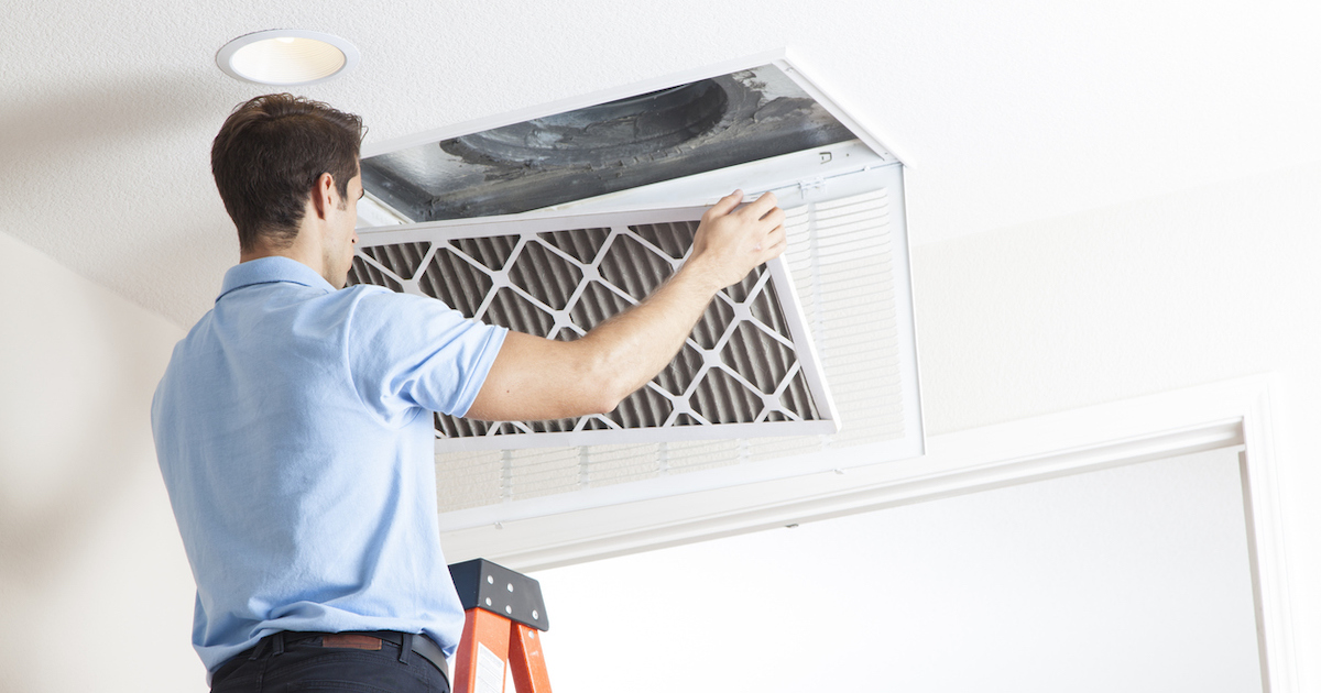 Man cleaning air ducts.