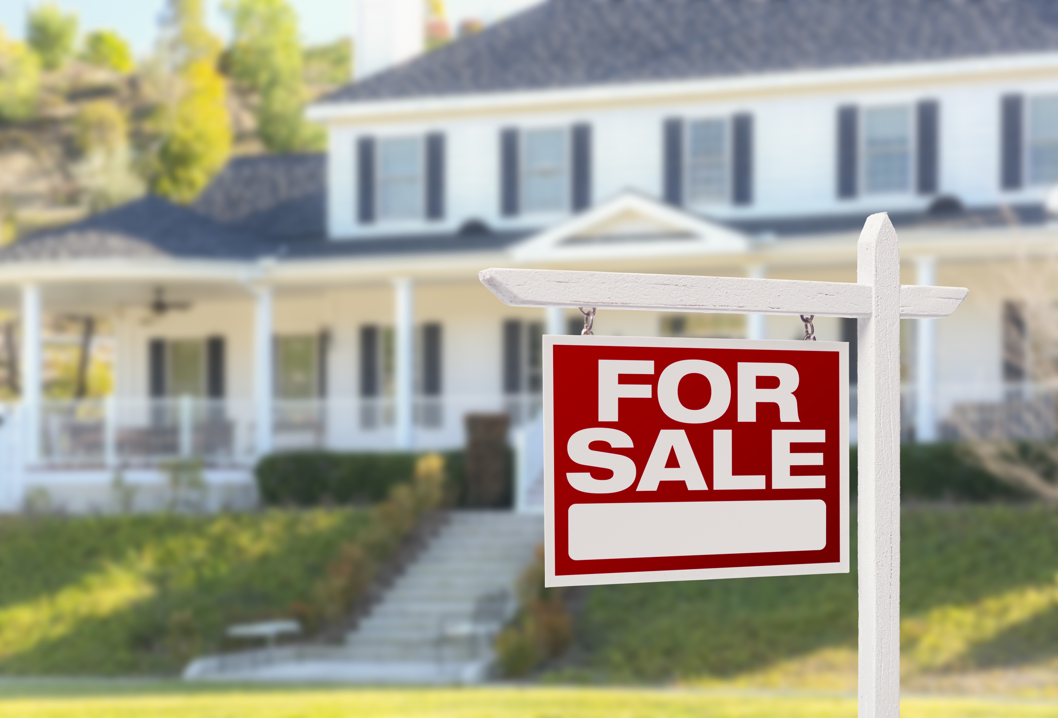 Home For Sale Sign in Front of Beautiful New House.